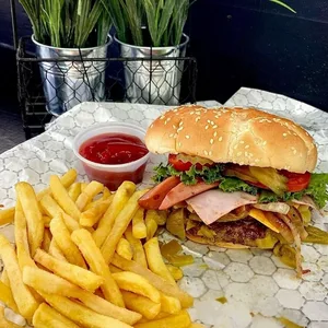 Burger with fries and ketchup served at Hatch Corner Snacks & More in Hatch New Mexico.