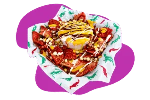 Chips topped with corn, cheese, and sauces from Hatch Corner Snacks & More in Hatch New Mexico