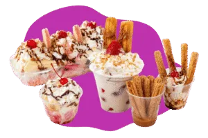 Assorted desserts with banana split, churros, whipped cream, cherries, and chocolate drizzle from Hatch Corner Snacks & More in Hatch New Mexico